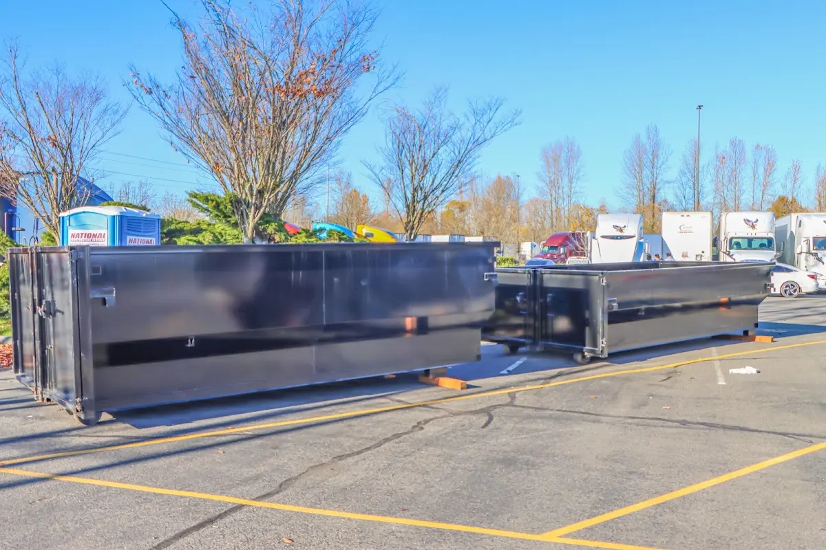 Professional dumpster rental service with roll-off container on residential driveway in Sylacauga